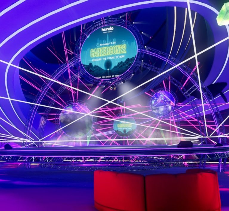 An avatar stands atop a glowing crystal platform, overseeing a club room with a main stage. Red, purple and blue are dominant colours