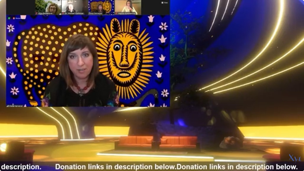 A curator presents famous art of Ukraine. A stylized lion painted in gold and blue is behind her.